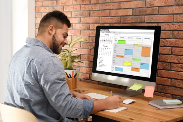 man scheduling date on calendar